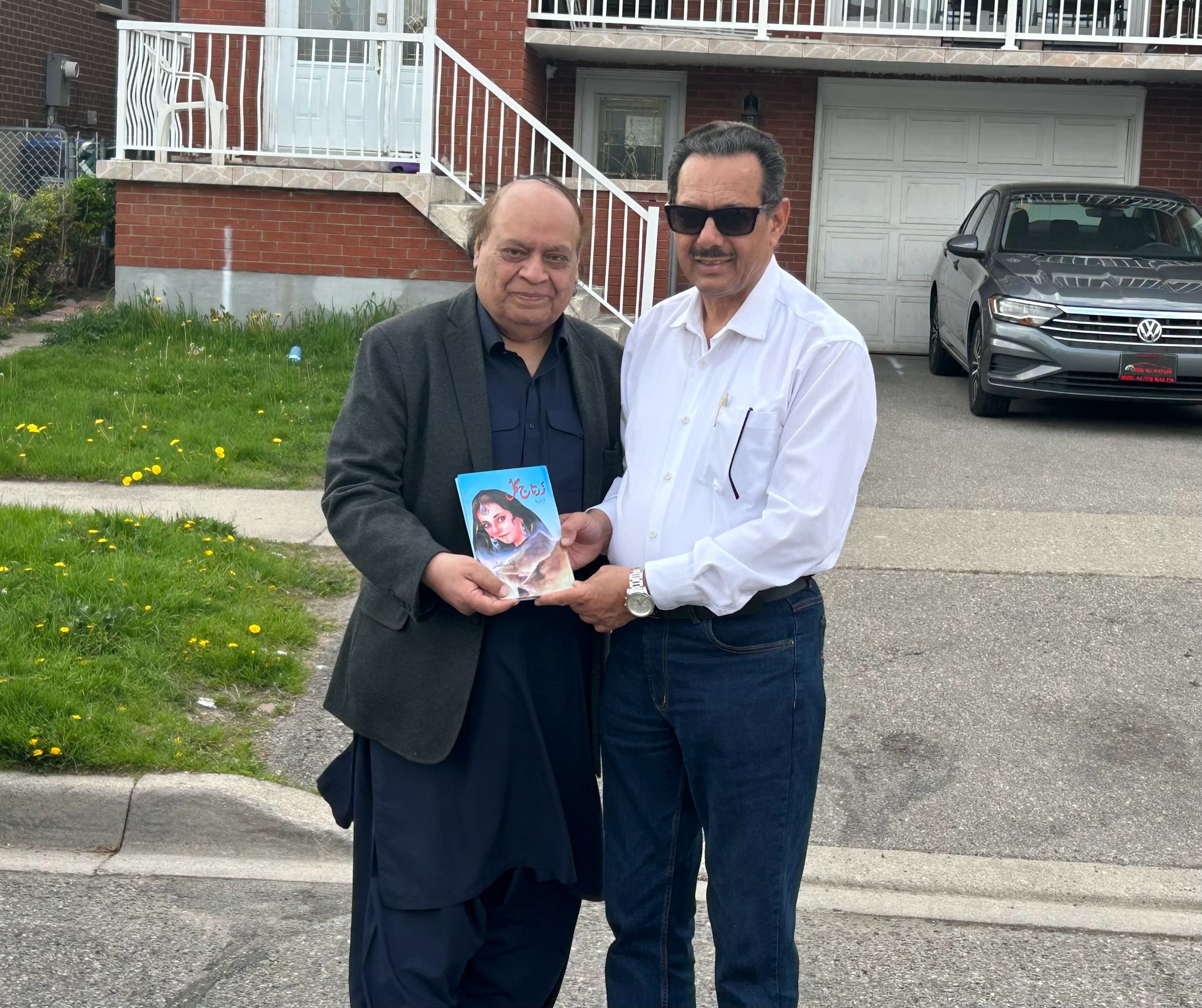 Shoaib Nasir Presenting His Novel “Zartaj Gull” to Nasir Ali Syed.